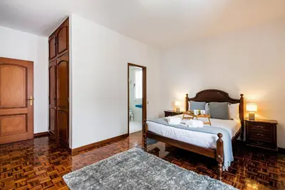 a bedroom with a bed and a large mirror at Villa do Carmo by GALMI in Funchal