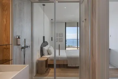 a bedroom with a bed and a view of the ocean at Savoy Monumentalis VII by An Island Apart in Funchal