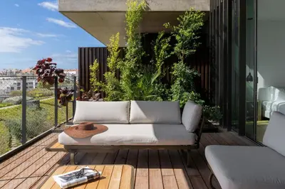 an outdoor living area with a couch on a balcony at Savoy Monumentalis VII by An Island Apart in Funchal