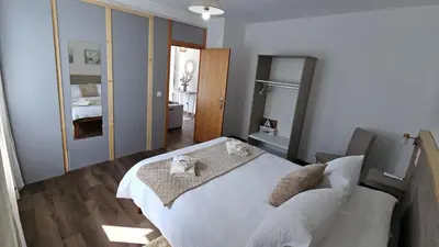 a bedroom with a white bed and a mirror at Lower Floor In Flor do Campo - Santana in Santana