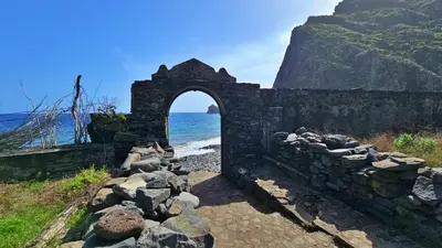 an old stone building next to the ocean at Lower Floor In Flor do Campo - Santana in Santana