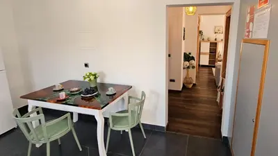 a dining room with a table and green chairs at Lower Floor In Flor do Campo - Santana in Santana