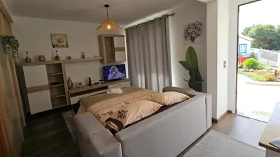 a bedroom with a bed and a couch at Lower Floor In Flor do Campo - Santana in Santana