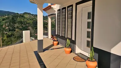 a balcony of a building with potted plants on it at Lower Floor In Flor do Campo - Santana in Santana