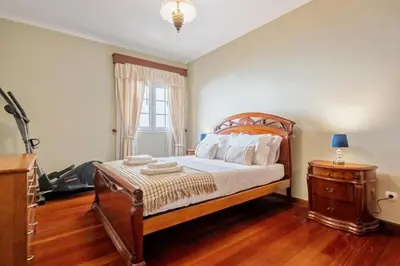 a bedroom with a bed and a dresser and a window at Ocean Hill View By Zest&Guest in Câmara de Lobos