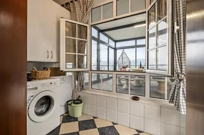 a laundry room with a washing machine and a window at Ocean Hill View By Zest&Guest in Câmara de Lobos