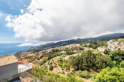 a view of a town on a hill at Ocean Hill View By Zest&Guest in Câmara de Lobos