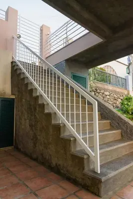 a staircase with a white rail next to a building at João Loft II by Mth in Campanário