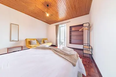 a bedroom with a large white bed in a room at João Loft II by Mth in Campanário