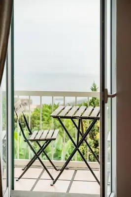 a table and a chair on a balcony at João Loft II by Mth in Campanário