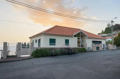 a white house with a fence in front of it at João Loft II by Mth in Campanário