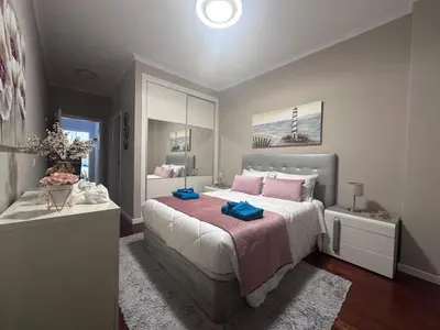 a bedroom with a large bed with pink pillows at Ocean View in Santa Cruz