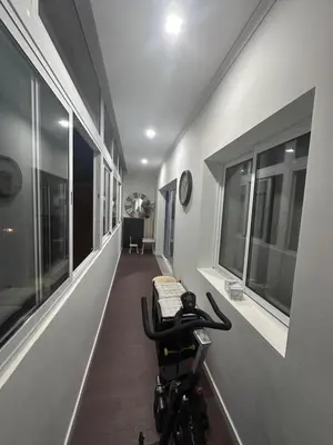 a hallway with windows and a table and a clock at Ocean View in Santa Cruz
