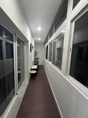 a hallway with windows and a bench in a room at Ocean View in Santa Cruz