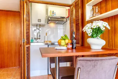 a kitchen with a table and a vase of flowers at Aida's Place, a Home in Madeira in Funchal