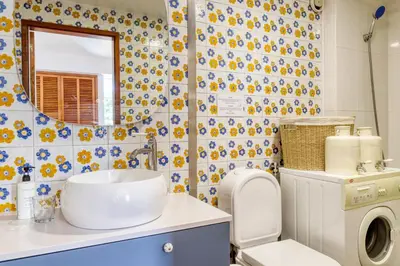 a bathroom with a sink and a toilet and a mirror at Aida's Place, a Home in Madeira in Funchal