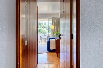a room with a door leading to a living room at Aida's Place, a Home in Madeira in Funchal