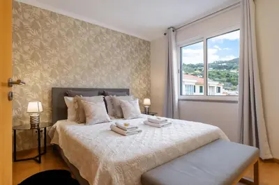 a bedroom with a large bed with a window at Sunflower Stay by Homie in Caniço