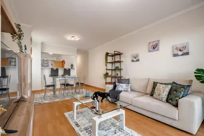 a living room with a couch and a table at Sunflower Stay by Homie in Caniço