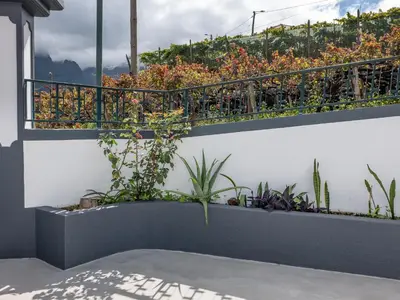a garden on a balcony with plants at Vista do Vale, By OP in São Vicente