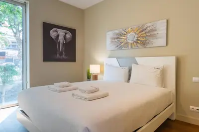 a bedroom with a large white bed with towels on it at FLH Oceanfront Luxury at Madeira Palace Residence in Funchal