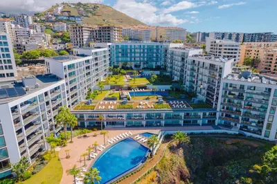 an aerial view of a building with a swimming pool at FLH Oceanfront Luxury at Madeira Palace Residence in Funchal