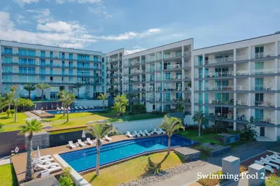 an aerial view of an apartment complex with a swimming pool at FLH Oceanfront Luxury at Madeira Palace Residence in Funchal