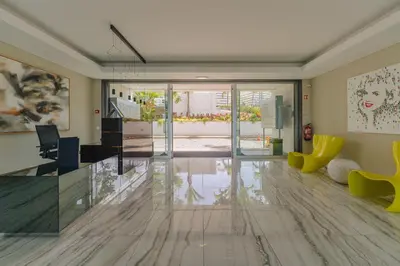 a living room with a table and yellow chairs at FLH Oceanfront Luxury at Madeira Palace Residence in Funchal