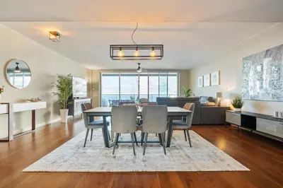 a dining room and living room with a table and chairs at FLH Oceanfront Luxury at Madeira Palace Residence in Funchal