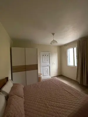 a bedroom with a large bed and a window at Casinha da Montanha - Paraíso 7 in Ribeira Brava