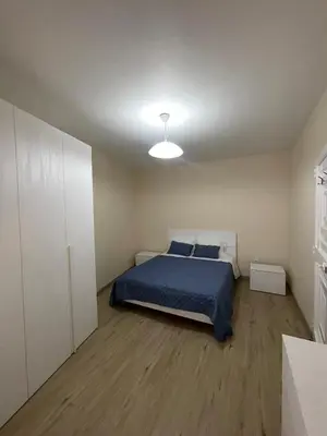 a bedroom with a bed with a blue comforter at Casinha da Montanha - Paraíso 7 in Ribeira Brava