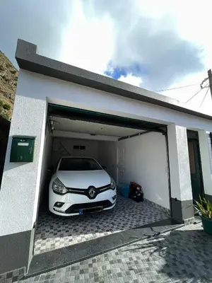 a white car is parked in a garage at Casinha da Montanha - Paraíso 7 in Ribeira Brava