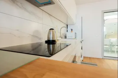 a kitchen with a stainless steel appliance on a counter at Figueira House in Santa Cruz