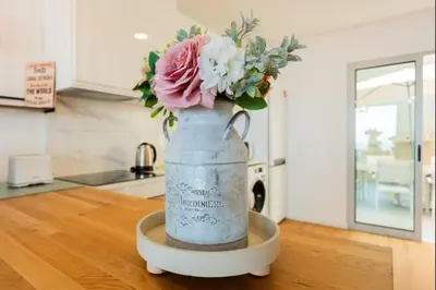 a vase filled with flowers on a counter in a kitchen at Figueira House in Santa Cruz