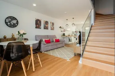 a staircase in a house with wooden floors at Figueira House in Santa Cruz