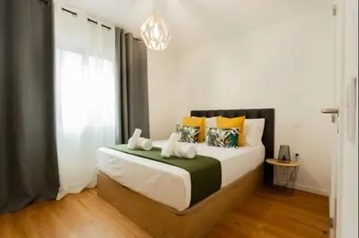 a bedroom with a large bed with pillows at Figueira House in Santa Cruz