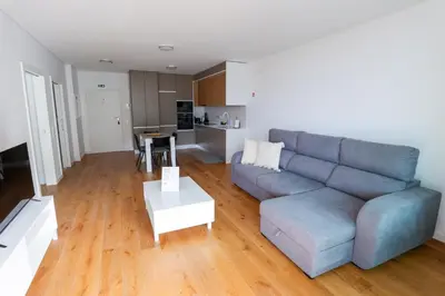 a living room with a blue couch and a table at Luxury LeilaMar Apartment - Modern Retreat in Funchal