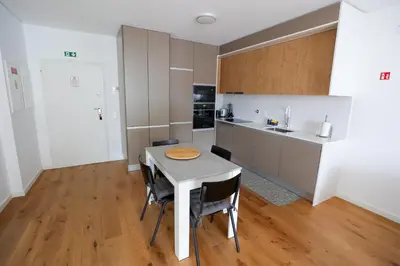a kitchen with a table and chairs in a room at Luxury LeilaMar Apartment - Modern Retreat in Funchal