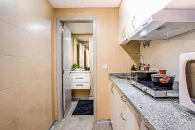 a kitchen with a stove and a sink at Funchal City Marina Apartment in Funchal