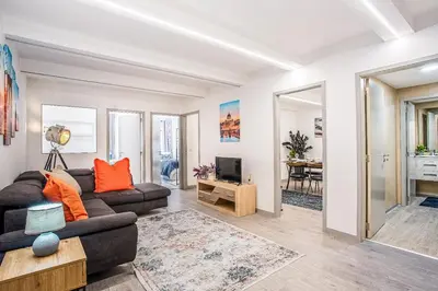 a living room with a couch and a tv at Funchal City Marina Apartment in Funchal