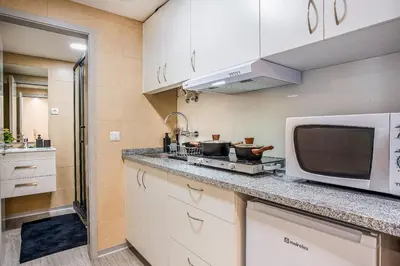 a kitchen with a microwave and a counter top at Funchal City Marina Apartment in Funchal