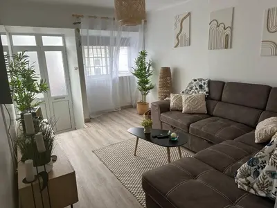 a living room with a couch and a table at Casinha Santa Maria in Vila do Porto