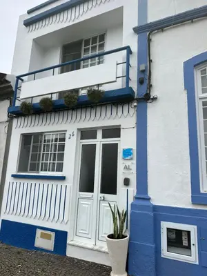 a blue and white building with a door at Casinha Santa Maria in Vila do Porto