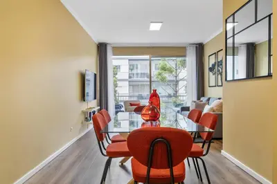 a dining room with a glass table and red chairs at SUPER Coral in Funchal