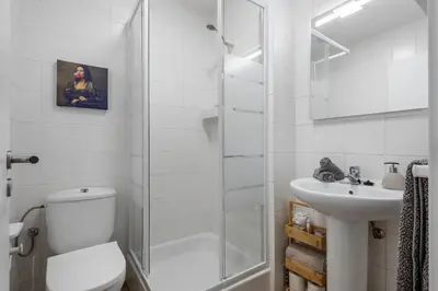 a white bathroom with a toilet and a sink at SUPER Coral in Funchal