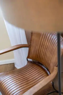 a brown chair sitting next to a table at SUPER Coral in Funchal