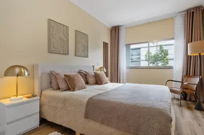 a bedroom with a large bed and a window at SUPER Coral in Funchal