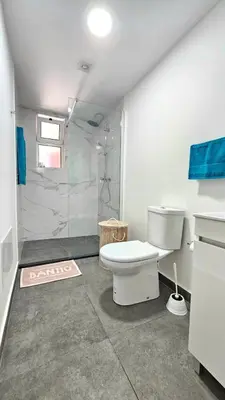 a bathroom with a toilet and a shower at Sol & Maré in Calheta