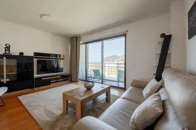 a wooden box filled with food next to a water bottle at Nomad Escape Spacious Apartment with Pool & Gym in Funchal