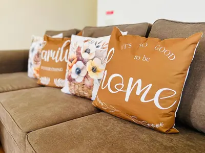 a couch with pillows on it with a it is no good to be at Maria do Mar Apartment in Caniço